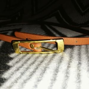 Tan skinny belt with gold belt buckle